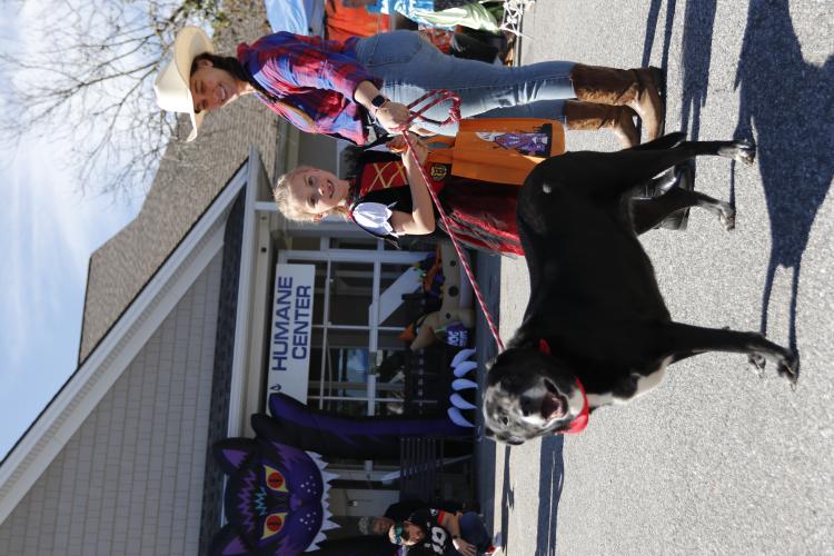 Madison (L) and Brittany McLendon hold the leash of Raven, an 8-year-old dog, at Madison Oglethorpe Animal Shelter on Saturday, Oct. 19. The shelter held their Halloween Costume Party on Saturday, and McLendon said it was their first time volunteering. "We plan to do this a lot more in the future," McLendon said. "We want to raise good humans." (Ella Kroll/The Oglethorpe Echo)