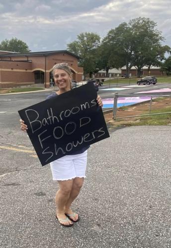 Roseanna Ames with Oglethorpe County Schools holds a sign and stands along Highway 78, in front of the OCHS gym. Those who stopped received spaghetti meals, bottled water and other necessities. Some took food to people affected by the damage and power outages. (Submitted Photo)