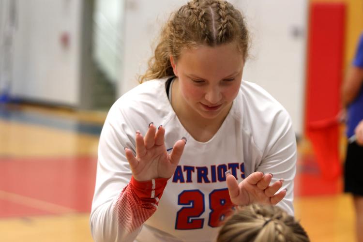 Senior Samantha Amos high-fives teammates in a match against Aquinas last fall. Her play has helped the Oglethorpe County volleyball team win seven consecutive matches. (Diana Lopez Garcia/The Oglethorpe Echo File)