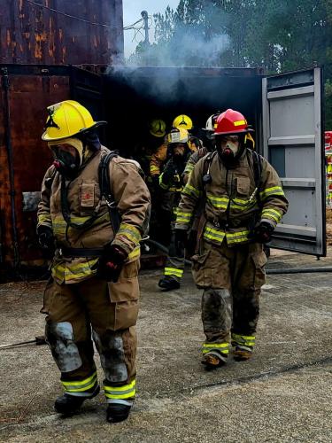 Brent Griffiths leads Vesta volunteer firefighters out of the smoke at Elberton’s fire training center. The firefighters participated in an annual live-burn training and go through weekly training sessions. (Submitted Photo/Jennifer King)