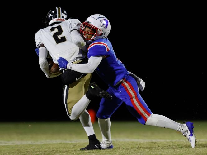 Oglethorpe County defensive back Jordan Johnson (1) tackles Commerce running back Jacari Huff (2) at Patriot Stadium Oct. 18. Johnson is part of a senior class that were freshmen during coach Mike Holland’s first season in 2021. (ADAM WALTERS/THE OGLETHORPE ECHO)
