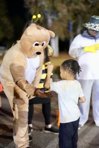 Blake Smith, pastor of the Crawford Pentecostal Church, passed out high-fives in addition to candy on Oct. 31. The pastor came fully decked out in a bear suit to promote the church and its trunk’s theme of “We Bee-Long to Jesus.” (Saylor Williams/The Oglethorpe Echo)