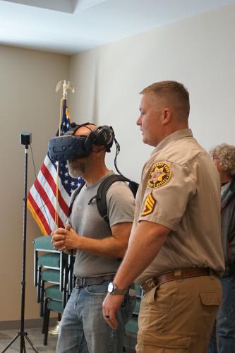 Sgt. JohnathanDuke assists pastor Aaron Reynolds with a virtual reality headset. (Alex Perri/The Oglethorpe Echo))