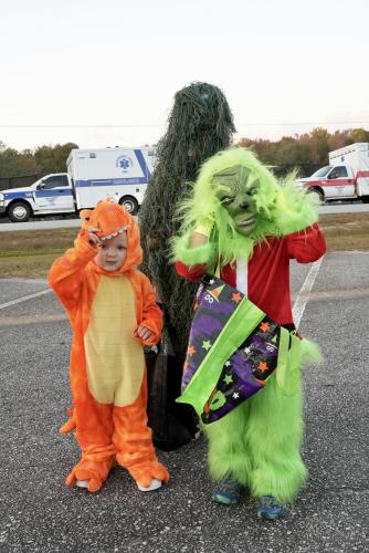 The Lambert brothers showed up ready for candy at the Oglethorpe County rec center. Two-year-old Beckett Lambert and five-year-old Beau Lambert stand in front of their older brother, Brantlee Lambert, who is 9, as they show off their costumes. While Brantlee said his favorite part of the event was dressing up, Beau said that his favorite part was the inflatable chicken walking around. (Saylor Williams/The Oglethorpe Echo)