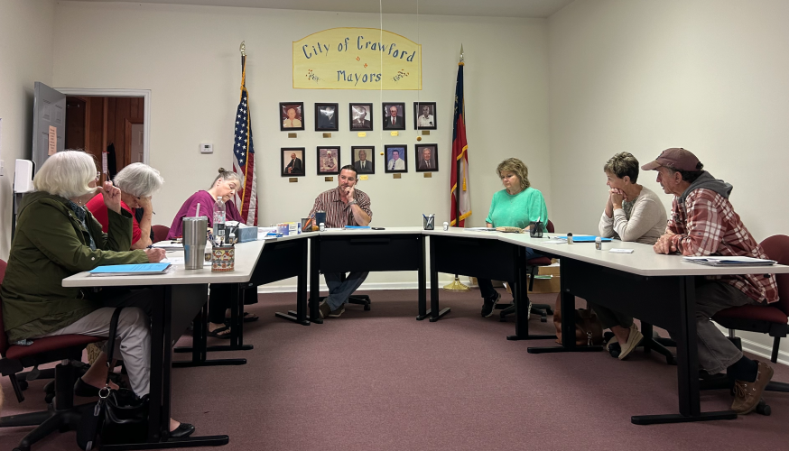 The Crawford City Council’s Sandra Sheridan (from left), Brenda Butler, city clerk Amy Wall-Lance, Mayor Seavy O’Neal, Kathy Little, Carol McGrath and Johnny Shedd unanimously decided to update the city’s budget in accordance with the waste water department by $1,440 a year on Tuesday night. (Photo/ Sarah Coyne)