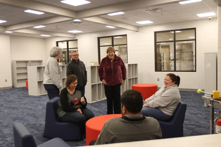 Susan Robinson (clockwise, from upper left), Tim Poole, Beverley Levine, Sue Ann Blalock, Guillermo Camacho and Becky Soto share a laugh in the media center of the new Oglethorpe County Elementary School on Tuesday. Levine and the board took a tour prior to the BOE meeting. (Avni Trivedi/The Oglethorpe Echo)