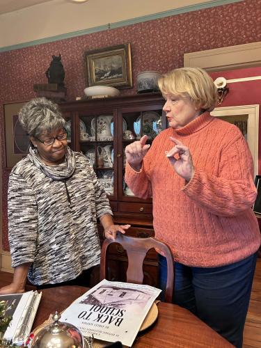 Maggie Mobley (left) and Ashley Simpson stand in Simpson’s house in Athens as they discuss her work with the Atlas Project and Mobley's experiences attending a one-room school house. Simpson has researched churches and schools in Oglethorpe County since the Digital Atlas Project started in 2020. (McCain Bracewell/The Oglethorpe Echo)