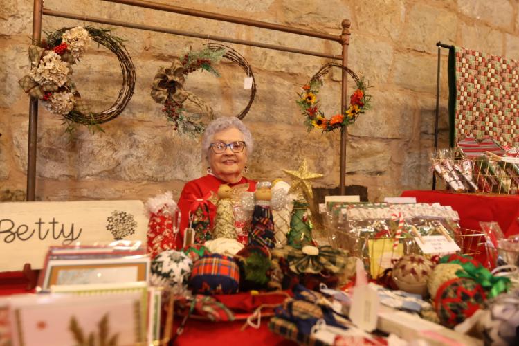 Betty Andrews displays cards and other items at her table at the Christmas Marketplace. Her business, called Cards by Betty, sells handmade wreathes, greeting cards, card sets, gift tags and more. (Photo/ Sarah Coyne)