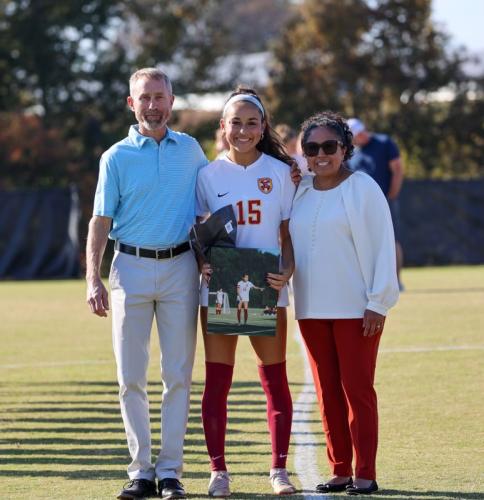 Lourdes Tompkins is accompanied by her parents, Darrius and Rita Tompkins, during Senior Day at Emmanuel University in 2023. Tompkins played at Emmanuel in between stops at Gordon State College and Belmont Abbey. (Submitted Photo)