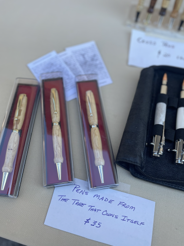 Mike Sellers, owner of Woodpappy Designs, showcases his unique handcrafted creations at Small Business Saturday in Lexington. Among his items are wooden pens made from a fallen limb of Athens’ landmark Tree That Owns Itself. Each pen includes a certificate of authentication, assuring customers the wood was ethically sourced from a naturally fallen branch. (Photo Credit/Chloe Beaver)