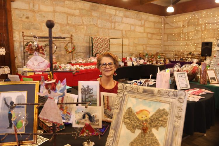 Lexington’s Ruth A. Jones displays items from her business, which is called I See ... Torn &amp; Twisted, Bits &amp; Pieces of This &amp; That on Sunday. Jones uses a variety of materials to create ornaments, prints and paintings that she sells. (Photo/ Sarah Coyne)