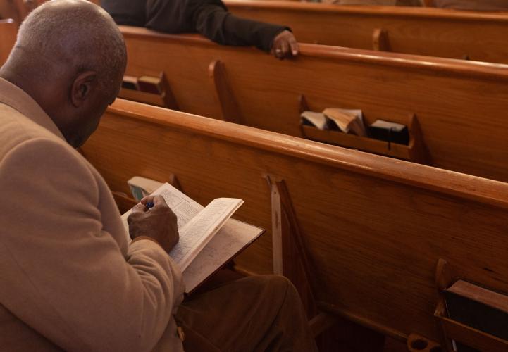 John Clark looks through a book of hymns during the annual Dr. Martin Luther King, Jr. Program sponsored by the Concerned Men of Oglethorpe County at Mt. Zion Baptist Church in Stephens, Georgia on Jan. 20, 2025. (Photo / Lux Corrona)