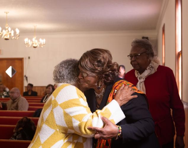 From left: Marie Galham and Grace Hunter embrace during a time of offering at the annual Dr. Martin Luther King, Jr. Program sponsored by the Concerned Men of Oglethorpe County at Mt. Zion Baptist Church in Stephens, Georgia on Jan. 20, 2025. The annual program first began in 2005 and aims to bring the community and youth of Oglethorpe county together in unity, modeled after the values of Dr. Martin Luther King Jr. himself. (Photo / Lux Corrona)