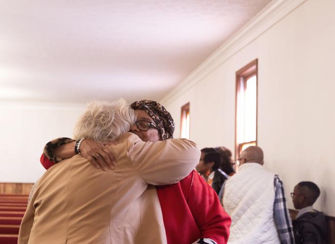 Sarah Jewell shares an embrace with a friend after the annual Dr. Martin Luther King, Jr. Program sponsored by the Concerned Men of Oglethorpe County at Mt. Zion Baptist Church in Stephens, Georgia on Jan. 20, 2025. The annual program first began in 2005 and aims to bring the community and youth of Oglethorpe county together in unity, modeled after the values of Dr. Martin Luther King Jr. himself. (Photo / Lux Corrona)