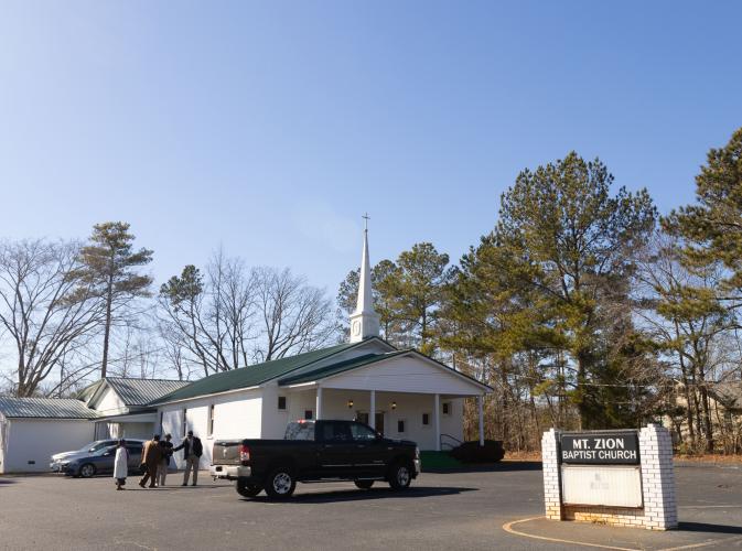 Attendees of the annual Dr. Martin Luther King, Jr. Program sponsored by the Concerned Men of Oglethorpe County stand outside of Mt. Zion Baptist Church in Stephens, Georgia on Jan. 20, 2025. The annual program first began in 2005 and aims to bring the community and youth of Oglethorpe county together in unity, modeled after the values of Dr. Martin Luther King Jr. himself. (Photo / Lux Corrona)
