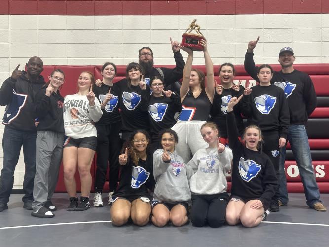 The OCHS girls wrestling team holds up trophy after winning the area dual tournament on Monday at Harlem. It was the first dual tournament win for the team, which is in its first year as its own program at OCHS. (Submitted Photo)