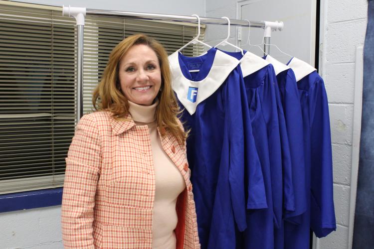 Renee McCannon, a mentor at the Oglethorpe County Foothills, poses with graduation robes. McCannon also is a mentor coordinator and REACH scholarship coordinator for Madison County Schools. (Bridget Goodman/The Oglethorpe Echo)