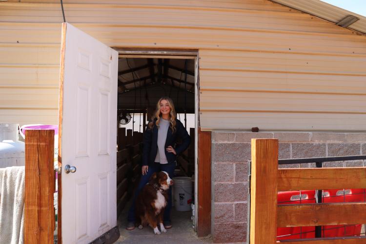Raegan Poulnott, 17, a senior at Oglethorpe County High School, and her dog, Nala, pose for a photo outside of their family barn. Poulnott has six pigs and has been raising and showing livestock in competitions in and outside of the county since she was just 3 years old. Poulnott competes as a showman, where judges evaluate her composure and technique in guiding her animals. (Photo/Lilly Stone)