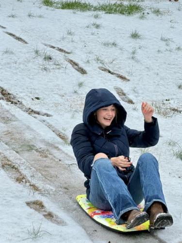 Arrington Clark, who is 13 and lives in Winterville, makes good use of the boogie board that she bought on Tybee Island. With no sled, the boogie board served as an excellent substitute. (Submitted Photo)