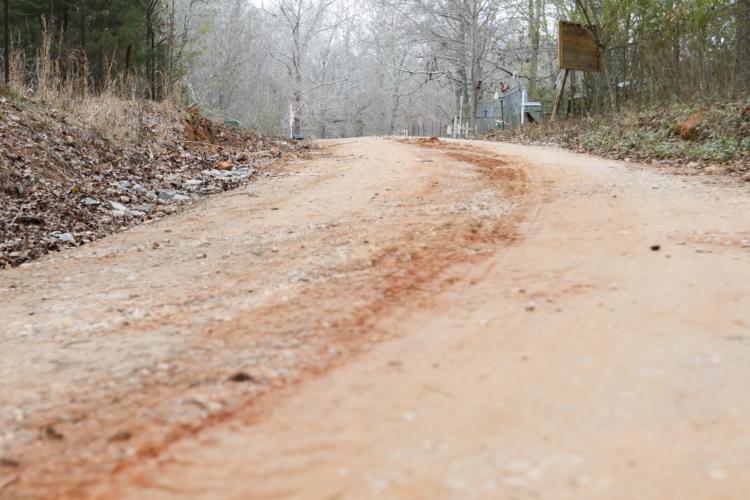 A close-up shot of Almond Drive on Wednesday, Feb. 5, 2025. Adam Nation, the Public Works Director for Oglethorpe County, takes pride in the work he does for the county. “A lot of people don't realize that when they leave their house every single day, they pull out onto a road, no matter if it's paved or dirt. And they're expecting it to be in good shape, and they expect it to be as safe as you can have it. And that's where our job is,” Nation said. (Photo/Felix Scheyer)