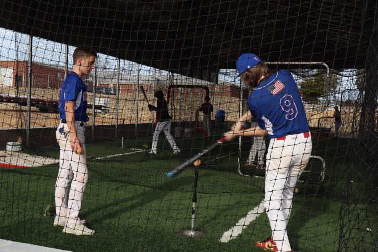 The Patriots take batting practice in the cages as part of their warm-ups. OCHS baseball split into "Team White" and "Team Blue" for the intrasquad scrimmage. (AVERY CAMERON/THE OGLETHORPE ECHO)