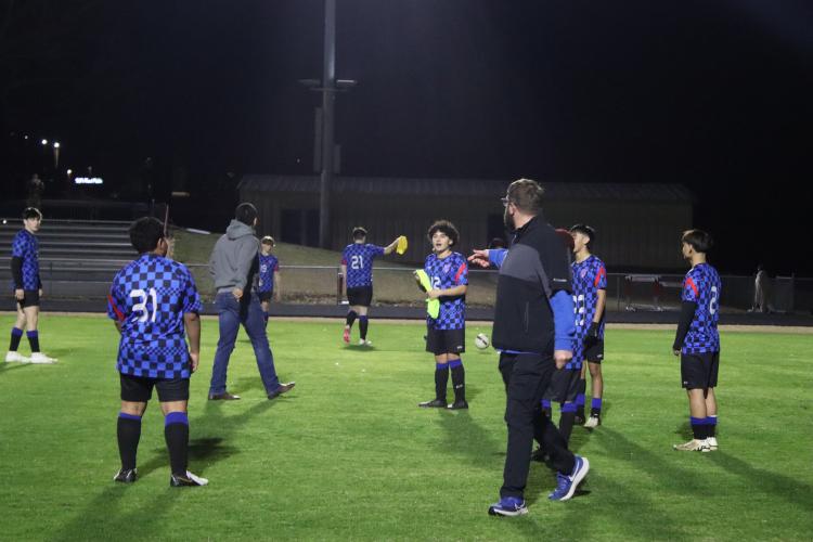 Coach Josh Austin warms up the players before the game against Monroe Area on Tuesday Feb. 18. Austin is in his first season as head coach in 2025. (Photo/ Kayda Hammock)