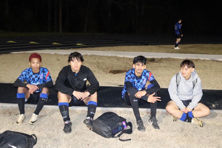 The OCHS boys soccer team waits for girls game to finish to start their season opener against Monroe Area on Tuesday Feb. 18. The photo includes (left to right) Elijah Jackson, Jeffery Molina, Jonathan Escalante and Saw Soe. (Photo/ Kayda Hammock)