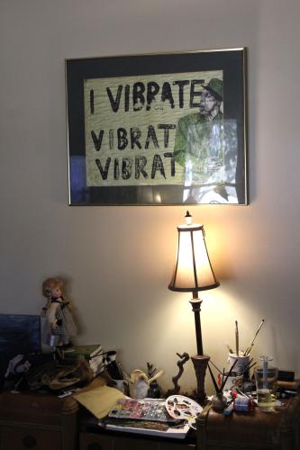 Sam Balling’s artwork hangs on the wall of his living room in his home in Lexington on Thursday, Jan. 30. Balling’s art tools rest on a side table in the living room, where he often creates while seated on the couch. (Photo/Emily Slepsky)