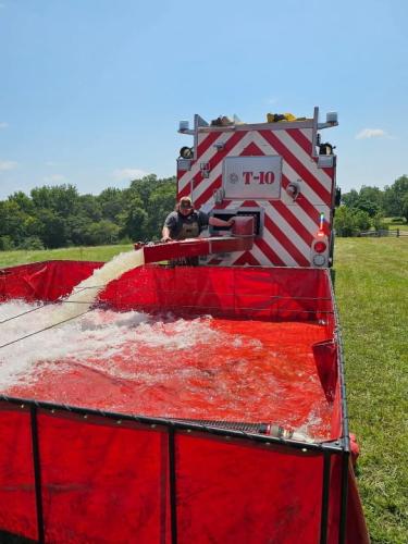 Firefighters from the Vesta Volunteer Fire Department demonstrate how to use the tankers and pools during a training session. The tankers help firefighters throughout the county fight fires where there’s a shortage of hydrants. (Photo submitted by Mike Moravek.)