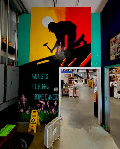 Sam Balling’s mural hangs inside the Habitat for Humanity in Athens. “They do repairs for home services, so right when you walk into the building, there's a tall painting I did for that,” Balling said. (Photo/Sam Balling)