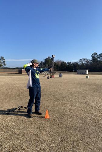Eleventh grader Nick Elder stands on the line at the OCMS soccer fields on Feb. 9. Elder is practicing for the state archery match on May 3 at the Rock Eagle 4-H Center. (Photo/Anna Izquierdo)