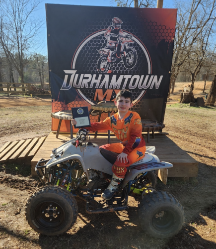 Mason Campbell, 8, poses with his DRR-65CC shifter at the Durham- town Off Road Track in Union Point earlier this month. Campbell is ranked second overall in his ATV class this year. (SUBMITTED PHOTO)