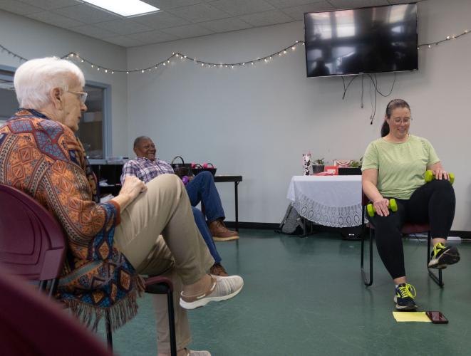 From left: Ginny Crafton and Charles Huff lift their legs in an exercise routine led by Sarah Baker at the Oglethorpe County Senior Center on Feb. 6, 2025. (Photo / Lux Corrona)