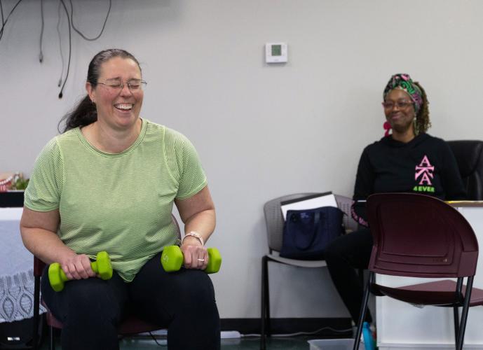 Sarah Baker laughs as she leads a group of seniors in an exercise routine at the Oglethorpe County Senior Center on Feb. 6, 2025. Sheryl Howard, the center's Activity Coordinator, smiles behind her as she watches. (Photo / Lux Corrona)