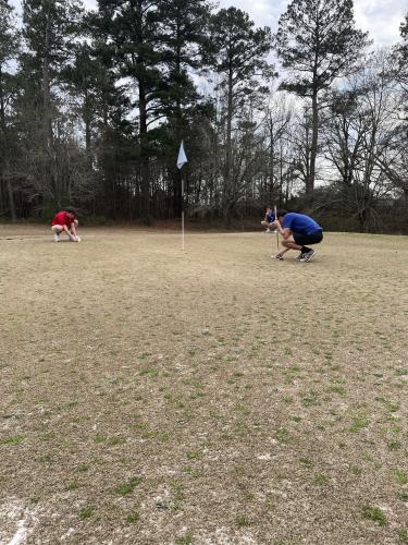 Senior golfer Bryce Frankel (left) and junior Caden Hartrum (back) are setting up to putt at the Washington Country Club on Feb. 27, 2025 against Washington-Wilkes High School. (Submitted Photo)