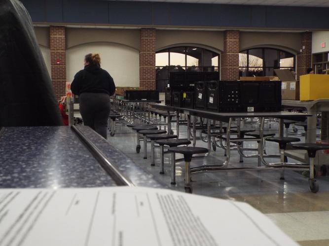 A bilingual form, available in English and Spanish, sits on a table as families fill it out before receiving a shopping cart at the mobile food pantry on Thursday, Feb. 20, at the Oglethorpe County Middle School. (Photo/ Luis Vaquero)