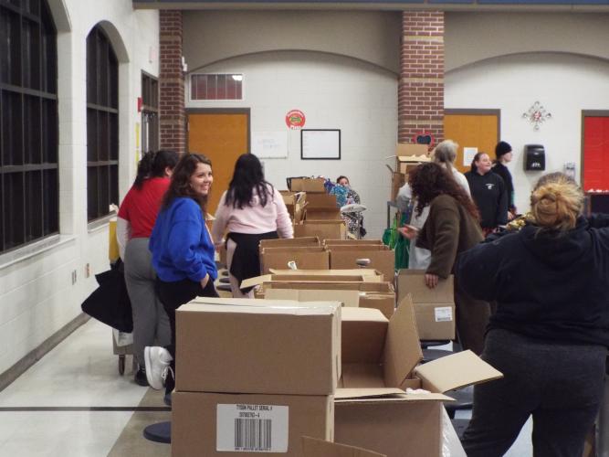 Volunteers and community members gather at Oglethorpe County Middle School on Thursday, Feb.20, as the mobile food pantry distributes fresh produce, canned goods, and other essentials to families in need. (Photo/Luis Vaquero)