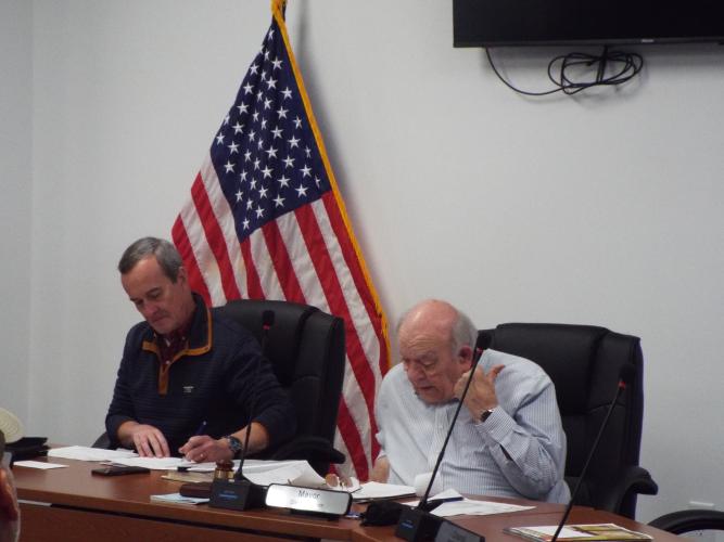 Mayor Danny Morcom speaks during the city council's monthly meeting on March 20, 2025, as council member Joel Kriner listens. Morcom addressed the need for infrastructure repairs, including $1,825 in approved funding to fix termite damage. (Photo/ Luis Vaquero)