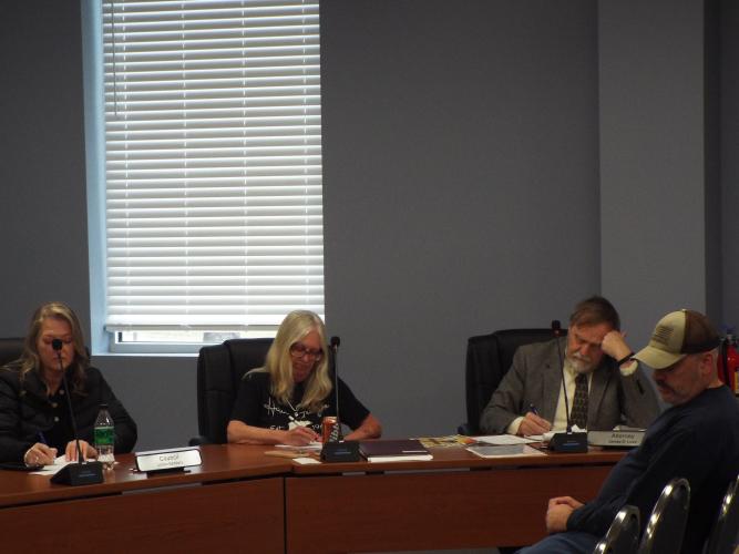 Lillian Sanders, City Clerk Dana Player, and City Attorney James Love listen during Thursday's Arnoldsville City Council meeting as officials discuss utility fee increases and infrastructure repairs. (Photo/ Luis Vaquero)