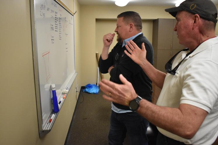 Jason Lewis (left) and Jeff Sharp discuss a road repair project on March 13, just three days after Lewis officially became the county administrator. He said he’ll work closely with Sharp and county clerk Amy Forrester. (Photo/Zach Leggio)