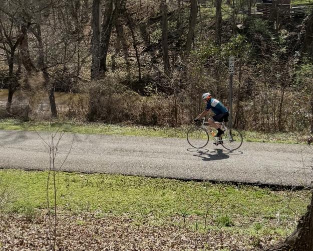 Bikers often ride along the 1.1-mile paved trail in Athens’ Dudley Park. The Athens Physical Therapy Ticket to Ride bike ride, which is scheduled for Saturday, runs through Oglethorpe County, along the route of the old railbed. (Photo/Anna Izquierdo)