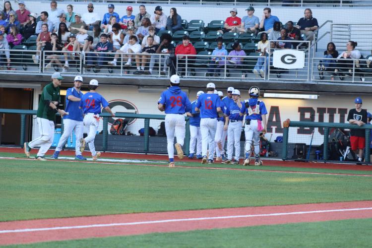 The Patriots file into the dugout after three outs against ACAD on Tuesday, March 19. (Photo/ Avery Cameron)