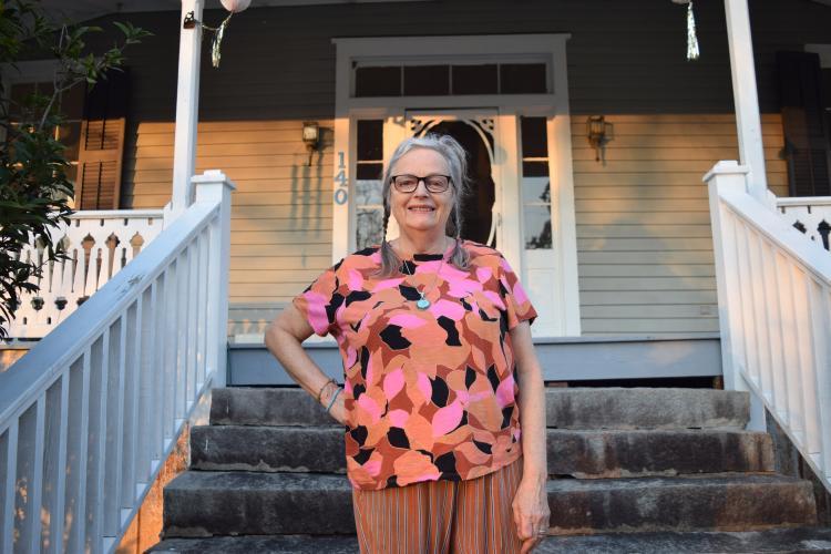 Rebecca Wood stands on the front steps of her home in Lexington, Georgia. Wood's yard was destroyed by feral hogs. (Photo/Jesse Wood)