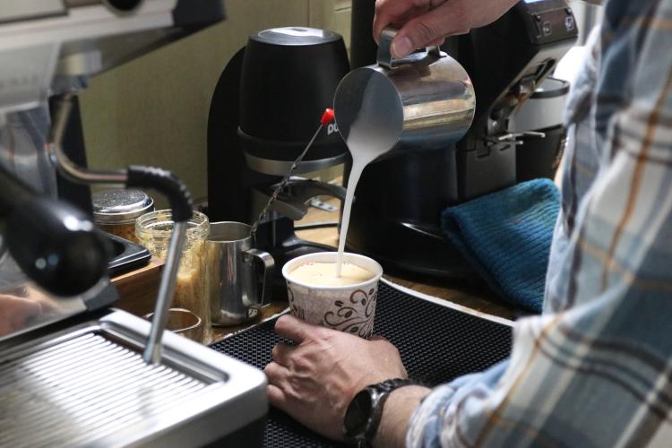 Co-owner Willie Torres pours steamed milk into a cup with brown sugar and espresso in Town and Country Kafe in Crawford, Ga., on Wednesday, Feb. 26, 2025. The Cuban coffee, made with espresso, brown sugar and steamed milk, is Town and Country Kafe’s best-selling coffee. (Photo/Adriana Cascio)