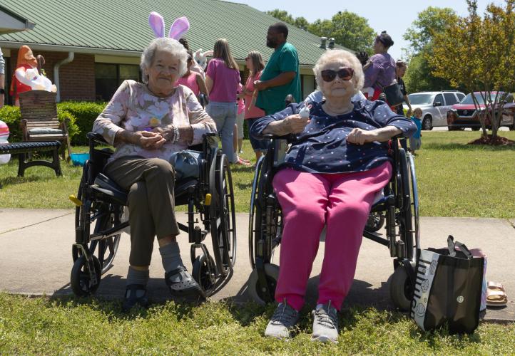 From left: Patsy Norris and Ann Jones pose for a portrait holding the decorated Easter eggs made for them by Cub Scout Pack 377 of Comer, Ga during the annual Easter egg hunt hosted by Quiet Oaks Nursing Home since 1992 in Crawford, Ga on April 13, 2025. (Photo / Lux Corrona)