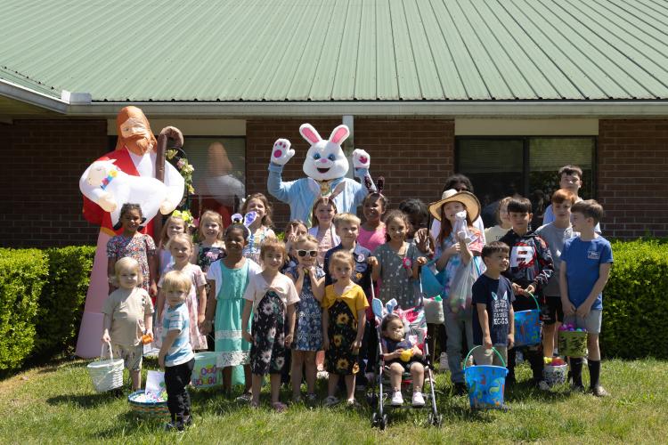 Children attending Quiet Oaks Nursing Home's annual Easter egg hunt pose for a portrait with the Easter Bunny and an inflatable Jesus Christ at Quiet Oaks Nursing Home in Crawford, Ga on April 13, 2025. (Photo / Lux Corrona)