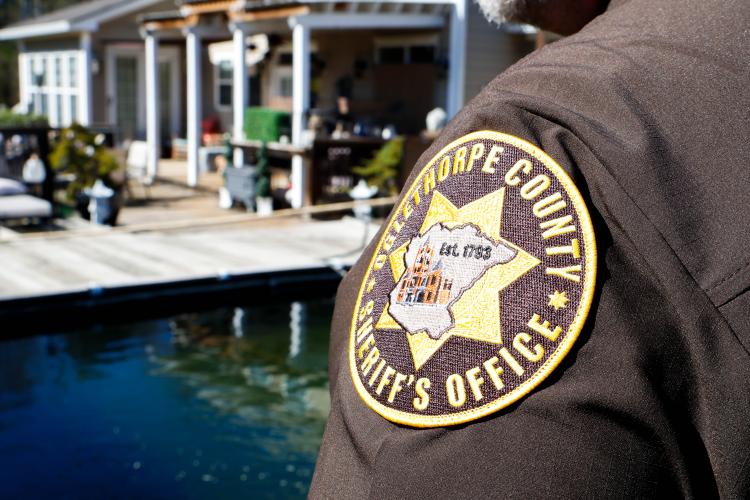 Sheriff David Gabriel stares out over his koi ponds within his backyard on Monday, March 17, 2025. In addition to being Sheriff of Oglethorpe County, Gabriel is also a koi judge with the American Koi Judge Association. When evaluating a fish, there are many factors at play. “Everybody thinks it's color and stuff like that. Body is 40% of the score. Then you start looking at quality and things like that, and that's 30% and then you have things like pattern. So you might have a fish that looks pretty but the