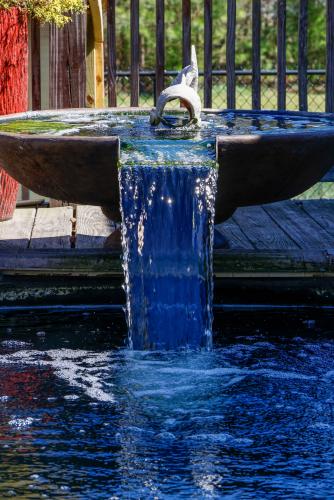 A small fish statue sits atop a fountain within the backyard of Sheriff David Gabriel on Monday, March 17, 2025. In addition to being an aesthetic addition, a running fountain helps promote aeration within a koi pond, which helps to ensure the health of the koi within. (Photo/Felix Scheyer)