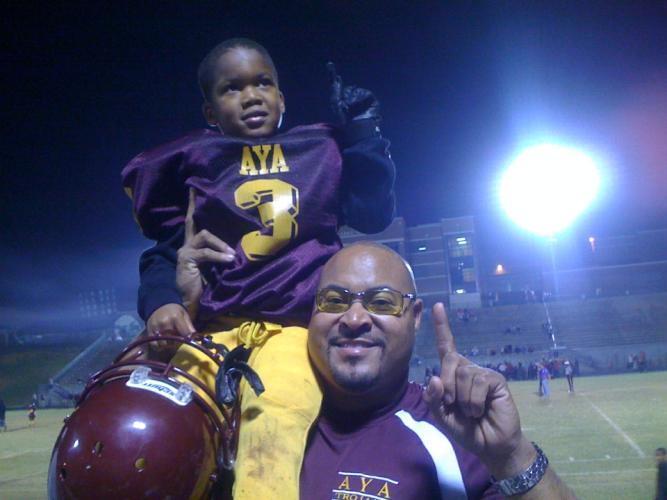 Jordan Johnson sits on his dad, James Johnson's, shoulder after a little-leauge football game. (Submitted photo)