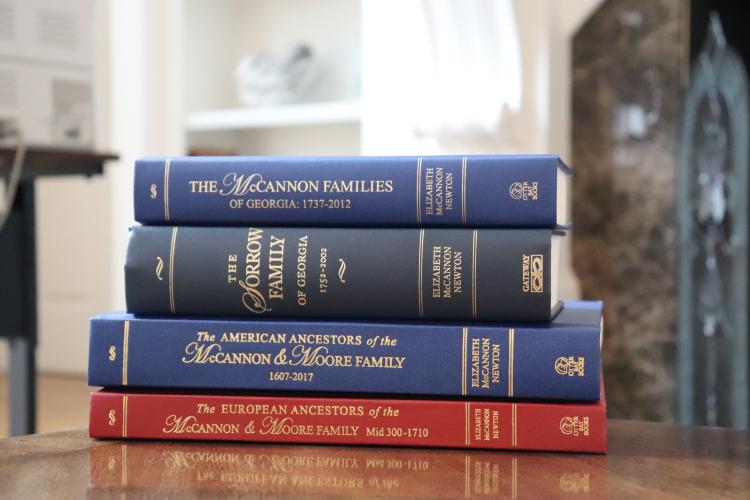 Four books of family genealogical history, written by Elizabeth Newton, sit on the coffee table at her Cumming residence on April 7, 2025. (Photo/Julianna Duennes Russ)